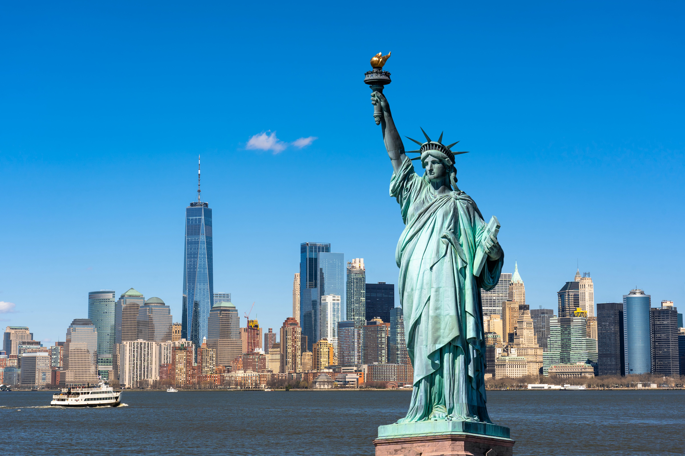 The Statue of Liberty stands tall in New York Harbor, gripping a torch…